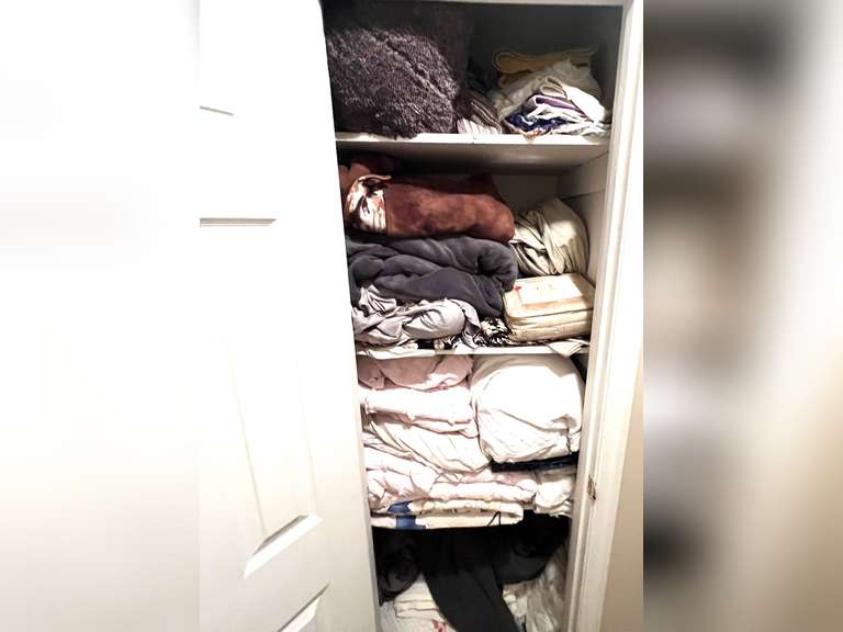 Hallway… Closet lot marked 1541, includes all content of storage closet. Some items include assorted bed coverings, wing chair slip cover, dish towels, bedspreads, quilt, and more. See pictures for details. image