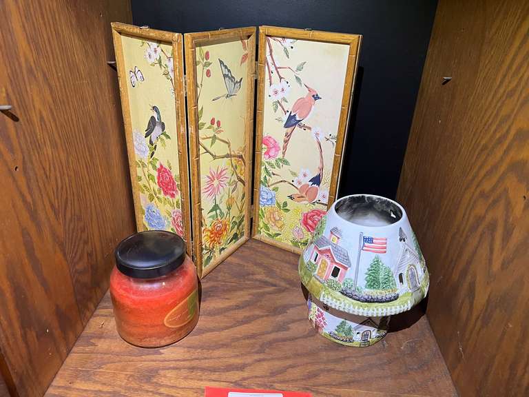 BR3…Shelf lot marked 1580 of assorted home decor to include a porcelain candle lamp, large candle, and decorative four panel table decor, see pictures for details. image