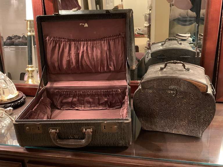 DECORATIVE WOODEN BOX COVERED IN METAL (HAS SEVERAL PLACES NEEDING TO BE GLUED) 11" WIDE X 9" TALL X 7" DEEP & VINTAGE LEATHER OVERNIGHT CASE (WON'T LOCK) 15" WIDE X 12" TALL X 6" DEEP - UP MASTER BED image