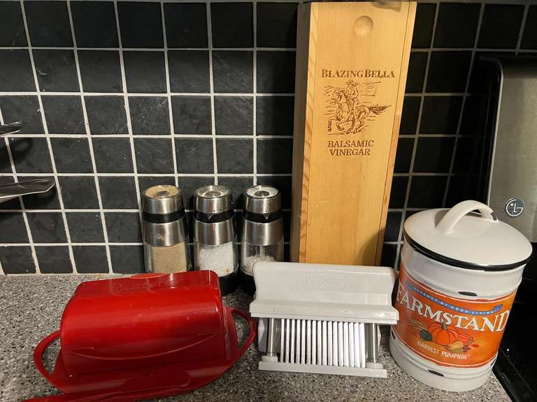 KIT… Assorted kitchen items to include a butter dish, jaccard, Oxo salt and pepper grinders, Blazing Bella balsamic vinegar with wooden storage box, and more. See pictures for details. image