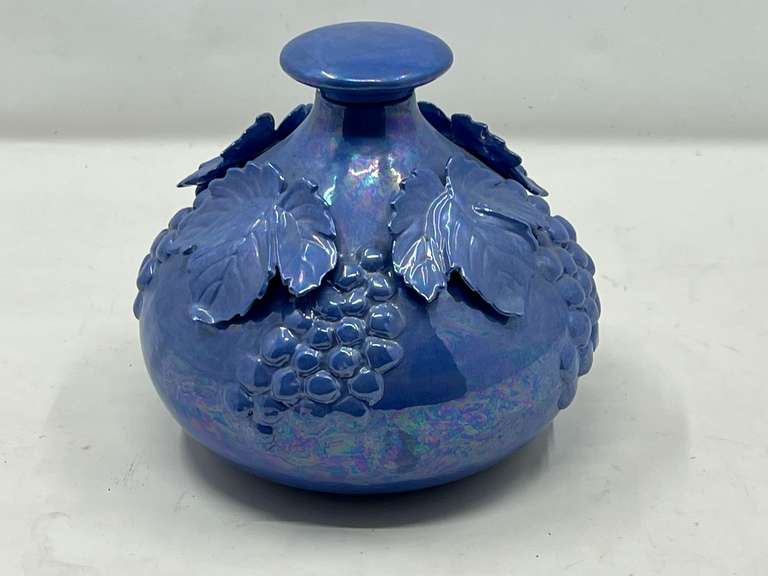 LR…Lovely blue iridescent ceramic jar/vase with lid, has embossed grape and leaf motif, see pictures for details. image