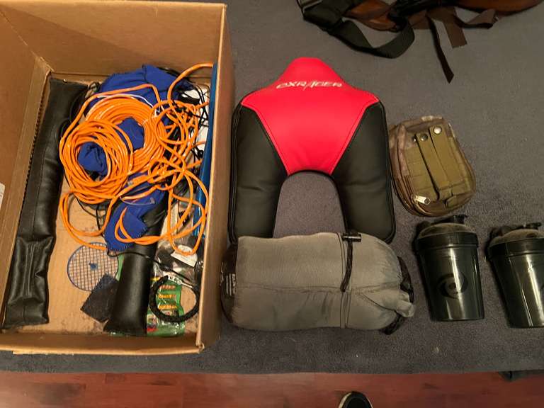 BR2…Assorted items to include Cat5 E data cable, Guide Gear sleeping bag, gaming chair headrest, shaker cups, and more. See pictures for details. image