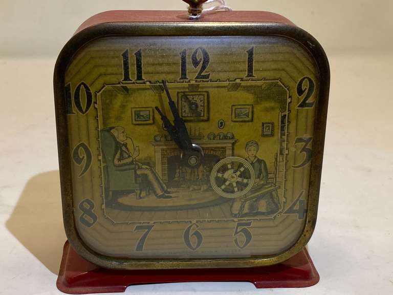LR…Vintage Lux Clock Manufacturing Co. animated "Spinning Wheel" wind-up alarm clock. It is a mechanical 30-hour alarm clock. 
The clock face has an art deco-style lithograph. See pictures for details. image