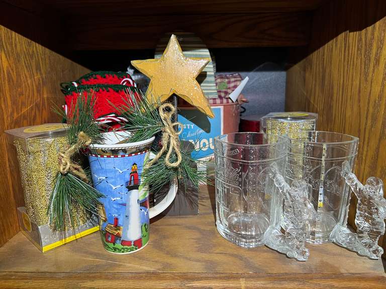 BR3… Shelf lot marked 1567, includes all content of shelf of assorted Christmas decor to include Coca-Cola Christmas mugs, Christmas stockings, flameless candles, and more. See pictures for details. image
