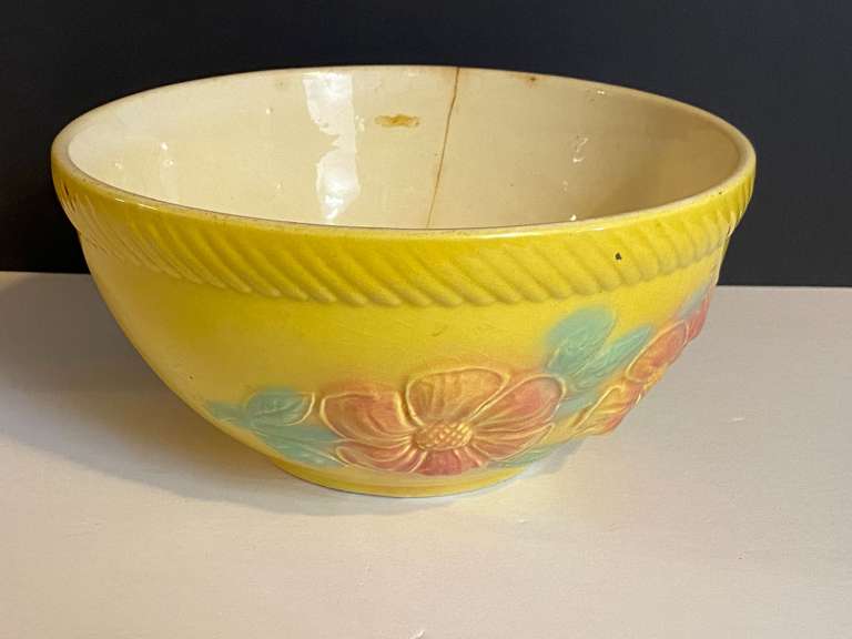 LR… Vintage ceramic oven proof mixing bowl, believed to be vintage Hull “Sun Glow” with embossed floral motif, this piece does have a crack, see pictures for details. image