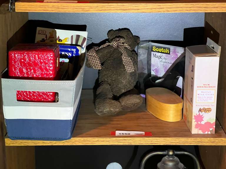 BR3…Shelf lot marked 1550, includes all content of shelf. Includes a skillet wind chime, teddy bear, high heel tape dispenser, and more. See pictures for details. image