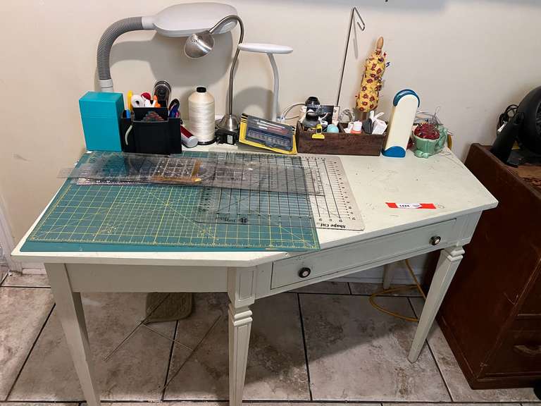 Laundry… Angled one drawer desk, this piece was used for a sewing desk, comes with assorted accessories to include desk lighting, cutting mat, rulers, and much more. See pictures for details. image