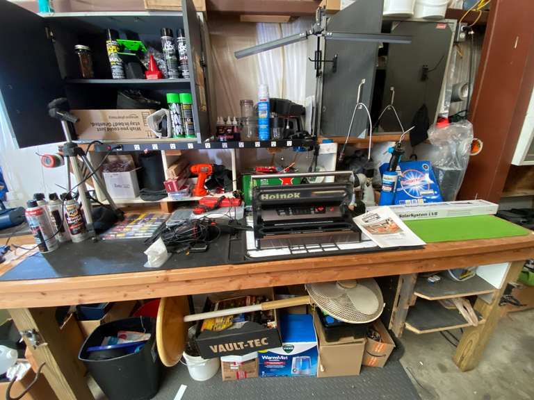 Content of shop bench and two cabinets, content only, items include a timing light, Cabela’s commercial vacuum sealer, cordless drills, small diecast cars in original packaging, oscillating floor fan, and much more. See pictures for details. image