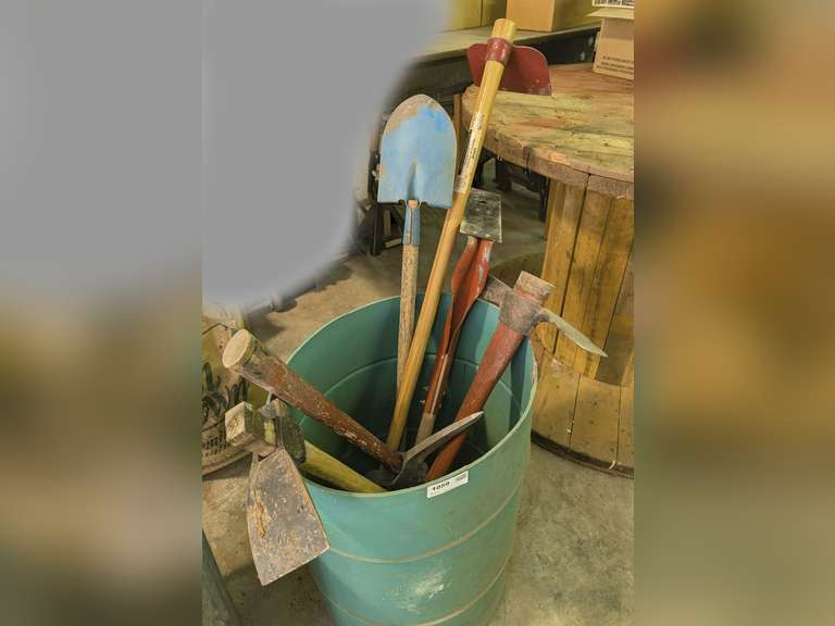 GARDEN TOOLS INSIDE BARREL MARKED 1059 INCLUDING MATTOCKS, PIC HOE, NARROW BLADE SHOVEL, AND MORE image