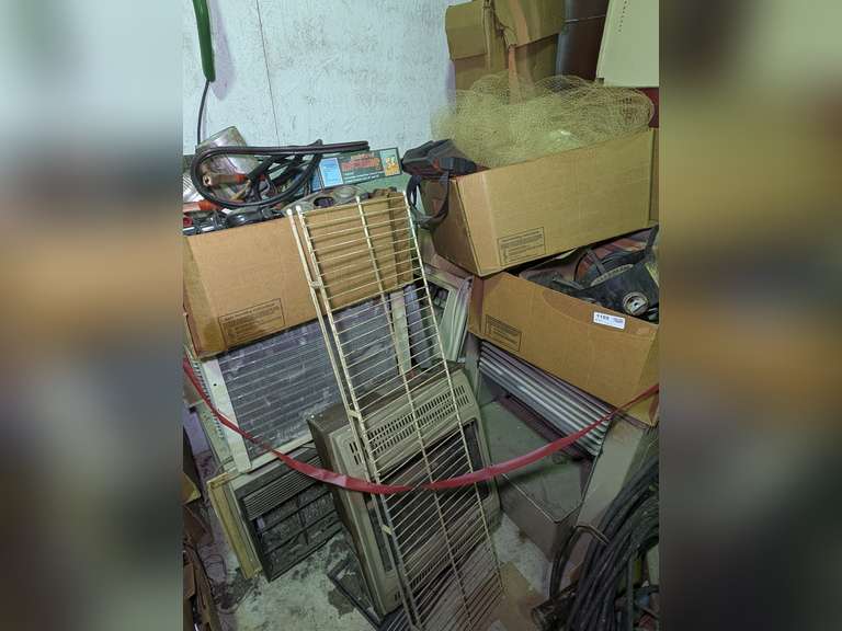 ALL ITEMS IN SHOP CORNER MARKED OFF AS 1102 INCLUDING WINDOW A/C UNITS, VINTAGE GAS HEATERS, MYSTERY BOXES WITH TOOLS (INCLUDING JUMPER CABLES, GAUGES, PAINT GUN(S?), FISHING CAST NET, SWIM FINS, AND MUCH MORE image