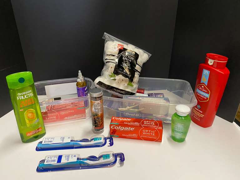 Shelf lot of assorted toiletries marked 6115 to include toothpaste, toothbrush, cotton balls, shampoo, body wash, and more. Tubs are not included, see pictures for details. ￼ image