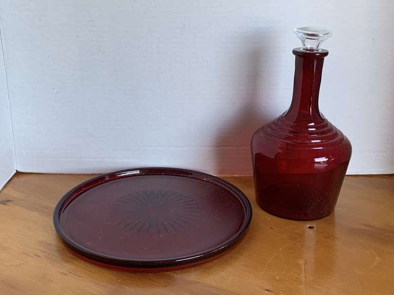 VINTAGE RUBY RED DECANTER W/ CRYSTAL STOPPER 9" TALL & RUBY RED ROUND PLATE 9 1/2" ROUND image