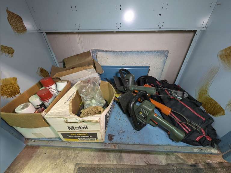 CONTENTS OF LOW SHOP CABINET MARKED 1037 INCLUDING THREE ELECTRIC HEDGE CLIPPERS, HUSKY TOOL BAG, SPRAY BOTTLES OF SHOP CHEMICALS, WEED TRIMMER SPOOLS, AND MORE image