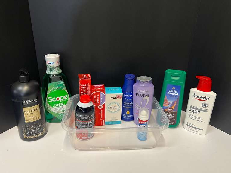 Assorted toiletries to include shampoo, Lysol, mouthwash, toothpaste, and more. Tub is not included, see pictures for details. image