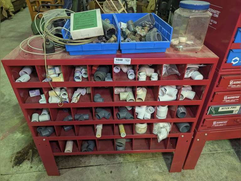 METAL CUBICLE SHELVING UNIT AND ALL PLUMBING PARTS INSIDE AND ON TOP image