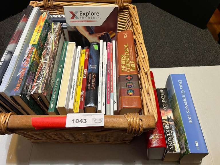 Book assortment with large woven basket, see pictures for details. image