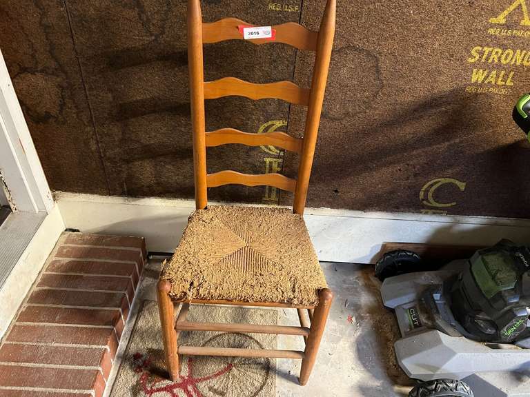 Garage… Ladder back dining chair with rush seat, the seat is very worn, this piece has a farmhouse look, matches lot 1221, see pictures for details. image
