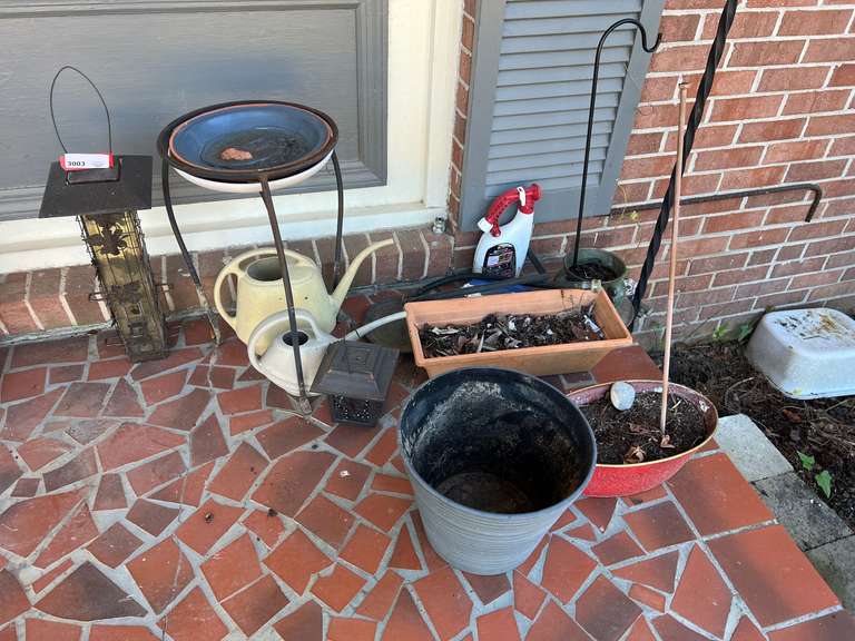 Front porch… Assorted planters, plant stand, birdfeeder, and more. See pictures for details. image