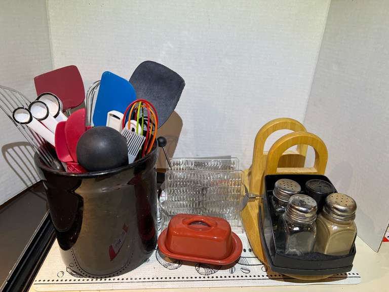 Assorted kitchen items to include utensil holder with utensils, butter dish, spoon rest, napkin holders, and more. See pictures for details. image
