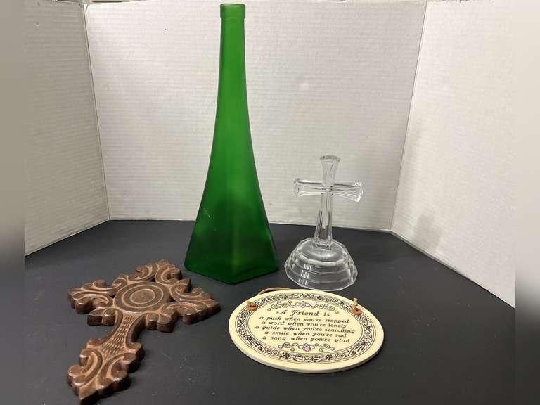BR2…Assorted home decor to include cast metal and crystal crosses, unusual angled collectible green glass bottle, and a Trinity Pottery wall plaque, see pictures for details. image