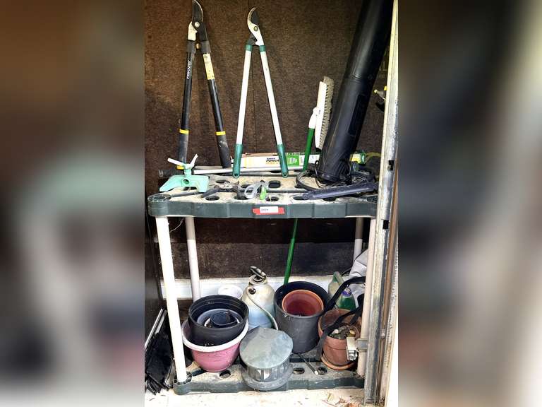 Garage… Plastic tool storage shelf, includes all content of assorted planters, loppers, and more. See pictures for details. image