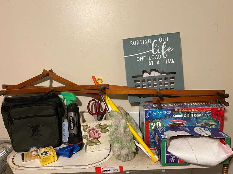 Laundry… Shelf lot marked 2008, includes peg rack, home decor, flashlight, and more. See pictures for details. image