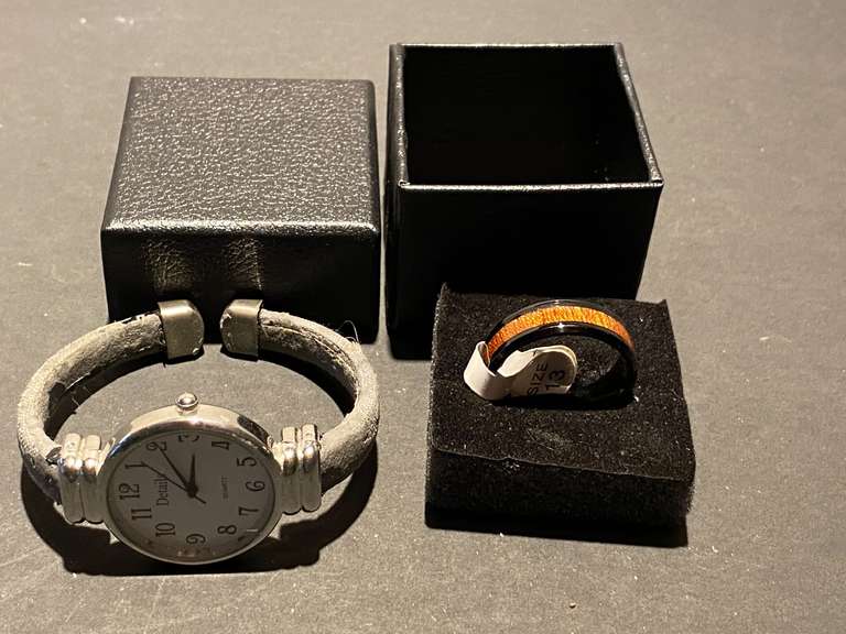 DR… Men’s black band with wood inlay ring, size 13, also includes a ladies Details bangle watch, see pictures for details. image