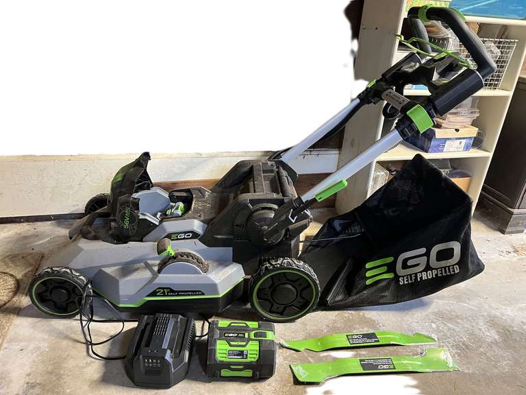 Garage…Ego 56 V battery powered lawnmower, 21” self-propelled, with grass catcher, comes with extra blades, battery, and charger. Powered up and ran when tested, see pictures for details. image