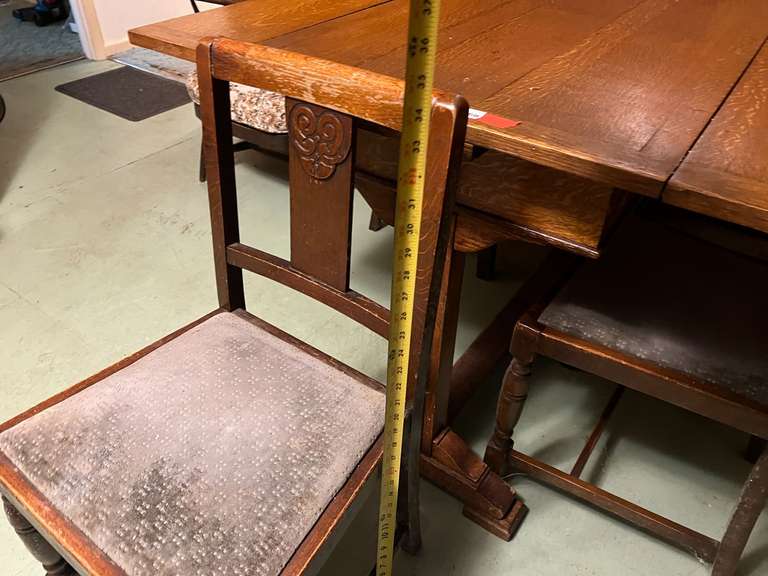 DEN… Antique slide leaf table, believed to be oak, the leaves on this unique piece slide forward under the table surface. Comes with four chairs, see pictures for details.