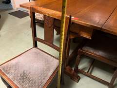DEN… Antique slide leaf table, believed to be oak, the leaves on this unique piece slide forward under the table surface. Comes with four chairs, see pictures for details.