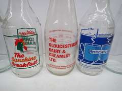 Collection of Vintage Glass Bottles with Advertising