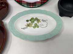 Assorted kitchen items to include a vintage Corona ironstone ware platter, restaurant style salsa bowl, vintage Bel-Terr brown glazed au gratin baking dishes, and plastic Christmas plate. Five pieces total, see pictures for detail details.