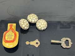 Vintage advertising clicker for Calvert Canadian whiskey, also includes vintage rhinestone buttons, clock key, and vintage address holder, see pictures for details.
