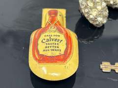 Vintage advertising clicker for Calvert Canadian whiskey, also includes vintage rhinestone buttons, clock key, and vintage address holder, see pictures for details.
