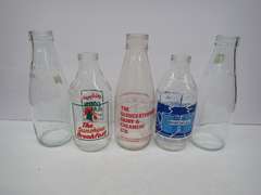 Collection of Vintage Glass Bottles with Advertising