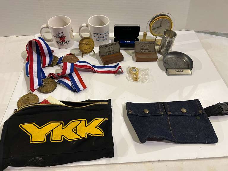 Mystery lot of assorted items to include a 40th anniversary YKK desk clock, coffee mugs, miniature pewter mug, belt pack, and more. See pictures for details. image