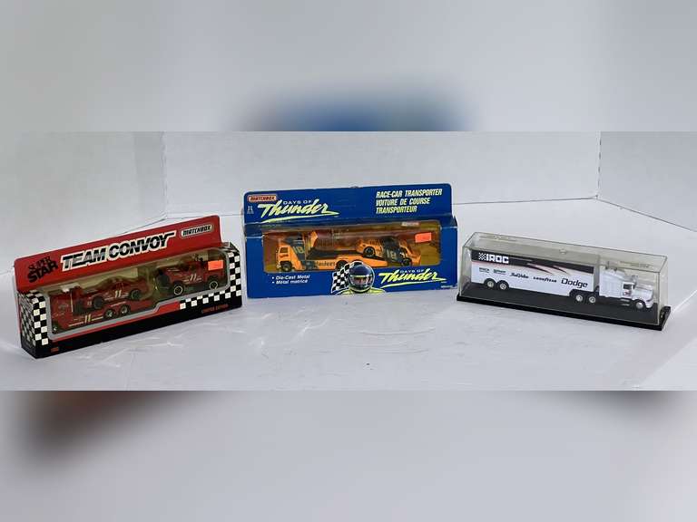 Racing diecast team/car transports and team convoy, three pieces, still in original packaging, includes “Days of Thunder”, Russ Wheeler #18, Bill Elliott, #11, and Iroc diecast transport with display case, see pictures for details. image