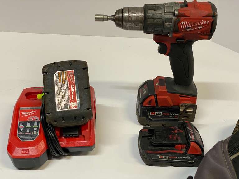 Milwaukee Cordless hammer drill, uses M 18 batteries, comes with three batteries, charger, and backpack. See pictures for details. image