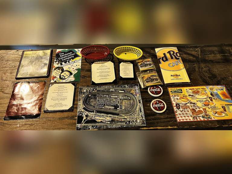 Assorted souvenir menus, Coca-Cola coasters, and racecar coasters. See pictures for details. image