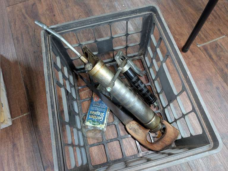 MILK CRATE AND CONTENTS INCLUDING GREASE GUNS, PRUNING SAW, AND GARDEN STAPLES image