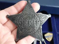 COIN COLLECTOR BOX & CONTENTS - INCLUDES HEAVY METAL SHERIFF BADGE, CROSS NECKLACE, C-5 AIR FORCE MEDALLION & MORE