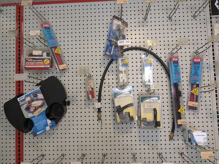 ASSORTED RV AND MARINE PARTS HANGING IN SHELF AREA MARKED 1053 INCLUDING WIPERS, DOOR LATCHES, ENTRY DOOR HOLDERS, CHAIR TRAY, OAR LOCKS, AND MORE image