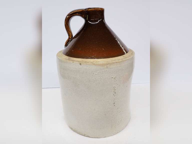 Antique Stoneware Jug with Brown Glaze Top - Filled with old pull tabs image