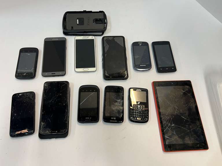 Cell phone assortment, some with cracked screens, tub is not included, see pictures for details. image