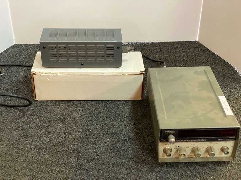 Assorted items to include a Hewlett-Packard 5300 B measuring system, does not power up, also includes a 1.5 KW HF – UHF dry dummy load, working condition unknown, and a two drawer metal file cabinet with missing handles, see pictures for details. image