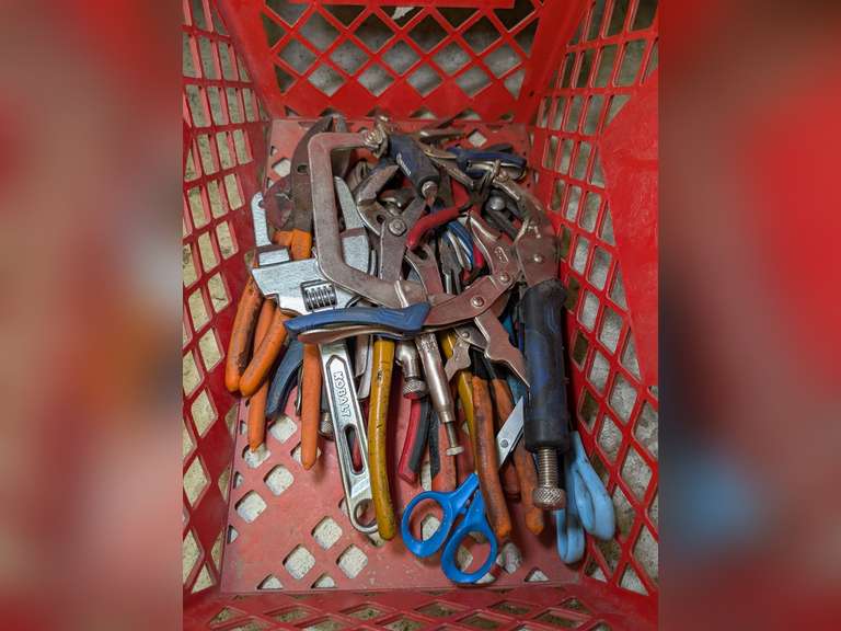 STAPLES BASKET FILLED WITH CLAMPING PLIERS, CHANNEL LOCKS, WIRE CUTTERS, SCISSORS, AND MORE image