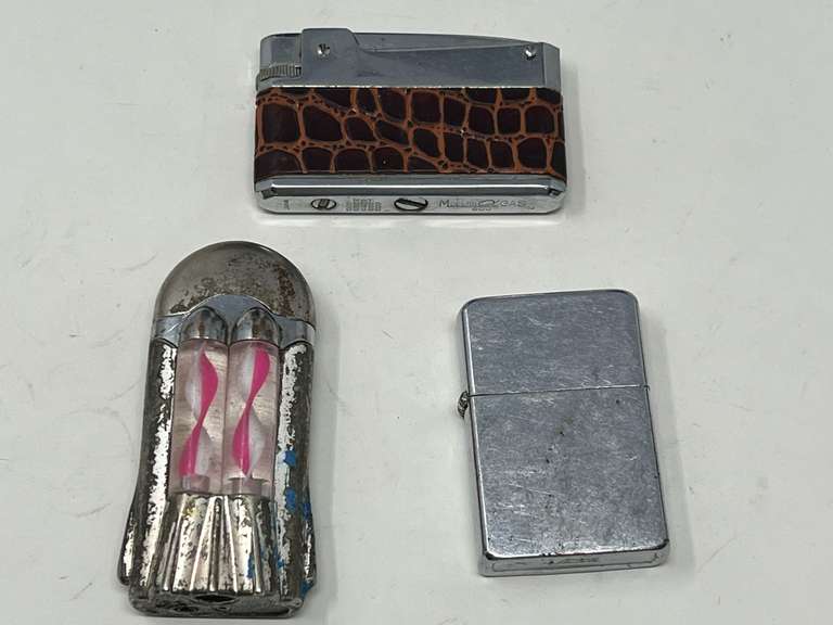 Cigarette lighters, three pieces, includes a vintage novelty lighter, see pictures for details. image