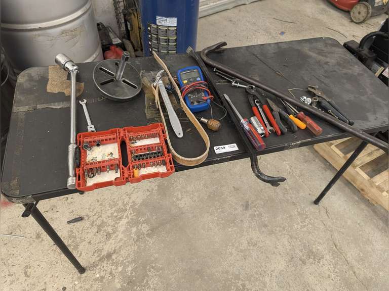 4-FT FOLDING TABLE AND CONTENTS INCLUDING BREAKER BAR, CEN-TECH CM300 MULTIMETER, STRAP WRENCH, CROWBARS, AND MORE image