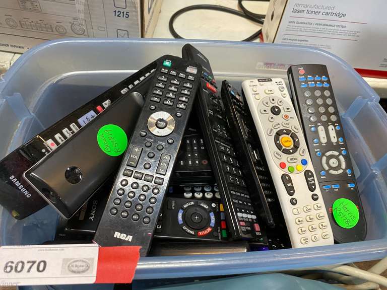 Tub of assorted remote controls, and more. See pictures or details. image