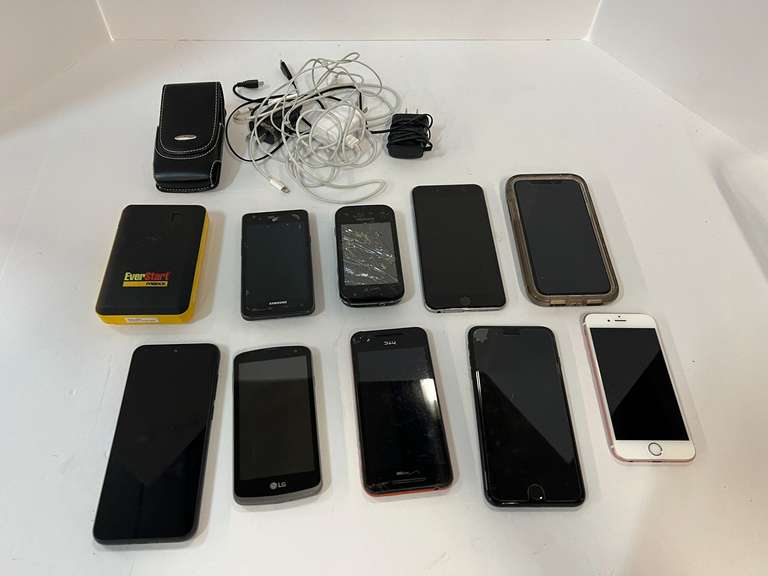 Cell phone assortment, some with cracked screens, tub is not included, also includes an EverStart portable battery charger, see pictures for details. image